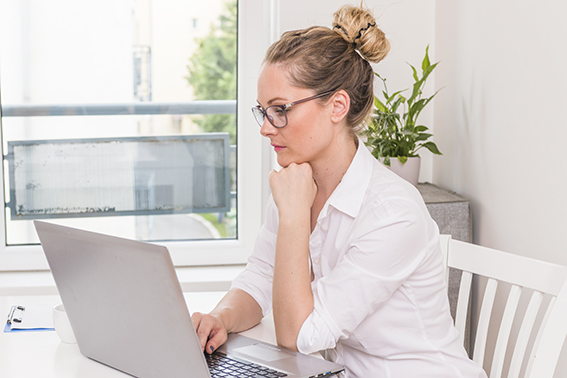 young-contemplated-businesswoman-looking-laptop